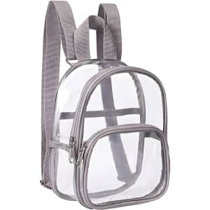 A clear mini backpack in transparent PVC with grey accents and two zippered compartments. It features adjustable straps.