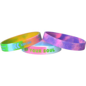 Three marble-coloured silicon wristbands in vibrant hues of pink, green, and yellow, featuring different logos and designs.