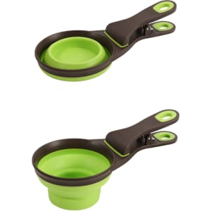 A collapsible pet food scoop in green and brown, featuring two sizes that nest together.