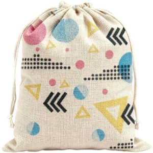 A patterned cotton linen drawstring bag featuring shapes in pink, blue, yellow, and black on a natural background.