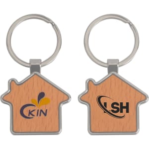A wooden keyring shaped like a house, featuring a metallic keyring and logos on both sides.