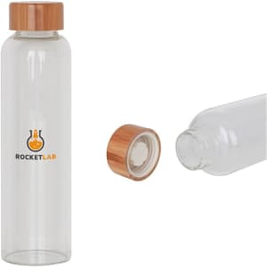 A drink bottle made of clear glass with a bamboo lid and a logo on the front.