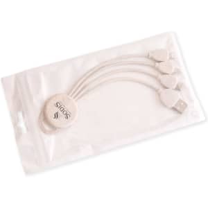A round-shaped charging cable in shades of beige, packaged in a clear plastic sleeve, featuring a logo.