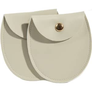 A pair of oval-shaped PU leather jewelry pouches in a light beige colour, featuring a snap button closure.