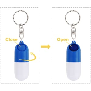 A blue and white pill capsule keychain with a round opening mechanism and a metallic keyring attachment.