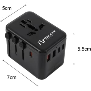 A black universal travel adapter with multiple ports and a logo, measuring 5cm by 5.5cm by 7cm.