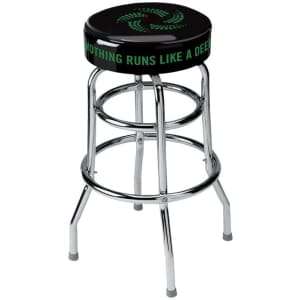 A black custom barstool with chrome legs and a logo on the seat featuring green text.