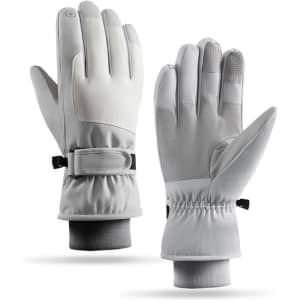 A pair of grey ski gloves with a snug fit and adjustable wrist straps, featuring a logo on the cuff.