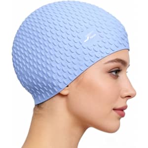 A premium silicone swimming cap in light blue with a textured surface and a logo.