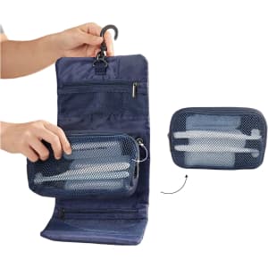 A navy blue folding travel toiletry bag with mesh zippered compartments and hooks for hanging. Features a logo.