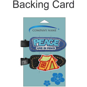 A backing card featuring two hair clips: one blue with "PEACE" and the other black with a red and yellow house design.