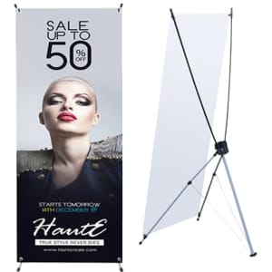 A medium X-frame banner in black and white, featuring a promotional design and a logo, stands on a tripod base.