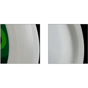 A white PE Frisbee with a green centre, featuring ridges on the outer edge.