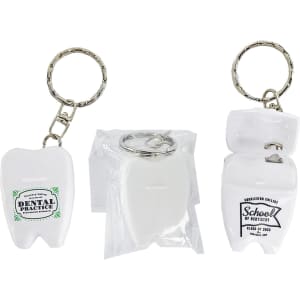 A white dental floss keychain shaped like a tooth, featuring a silver keyring and a logo on one side.