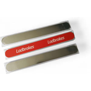 Three emery nail files in transparent packaging, featuring a shiny silver side and one red file with branding.
