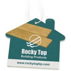 A house-shaped air freshener in teal and wood design, featuring a logo and a hanging string.