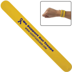 A yellow silicone snap wristband featuring a logo and text supporting troops.