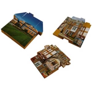 A large puzzle shaped like a house, featuring images of a brick facade and interior rooms in warm colours.