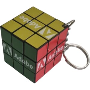 A Rubik's Cube keyring in green, yellow, red, and black with a branding logo.
