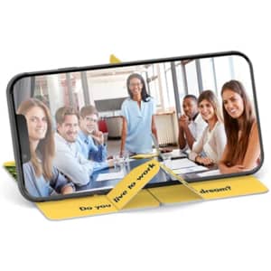 A yellow pop-up slider phone stand displays a smartphone featuring a group photo of smiling individuals in a meeting setting.