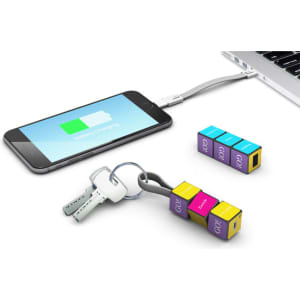 A mobile charging cable set in vibrant colours, featuring keys and a charging phone connected to a laptop.
