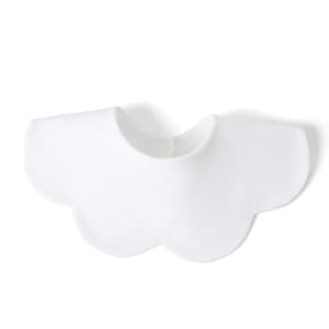 A white bib made from 100% organic cotton interlock, featuring a scalloped edge and a closure at the neck.