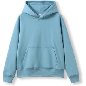 An oversized hoodie in a soft blue colour, featuring a front pocket and a large hood. It has a logo.