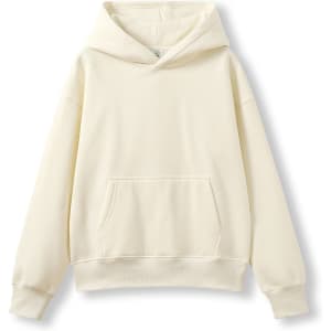 A cream-coloured oversized hoodie with a front pocket and a large hood. It features a logo on the tag.