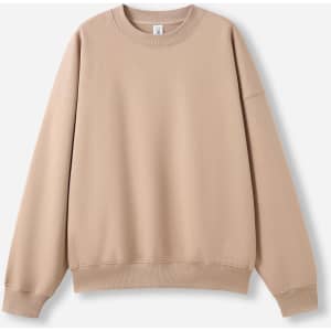 A beige oversized crew neck fleece jumper with long sleeves and a ribbed hem, featuring a logo.