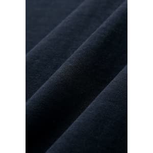 A close-up of dark navy combed cotton fabric, showcasing soft texture and smooth finish.