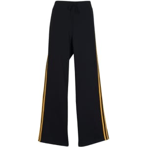 Black track pants with yellow stripes down the sides, featuring a drawstring waistband and a relaxed fit.