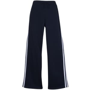 Women's striped track pants in navy with white side stripes and an elastic waistband. Features a logo.