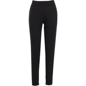 Black women's track pants made from brushed fleece, featuring a comfortable waistband and pockets. Includes branding.