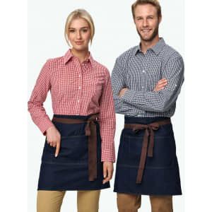 Denim half aprons in dark blue featuring brown ties, displayed on a male and female model wearing checkered shirts.