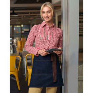 A denim half apron in dark blue with a brown tie, worn over a red and white checkered shirt.