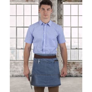 A denim half apron with a brown waistband, worn by a person in a blue checked shirt, against a city skyline backdrop.