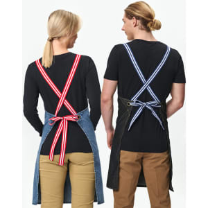 Denim bib apron in blue with contrasting striped ties, featured on two models wearing black shirts and beige pants.