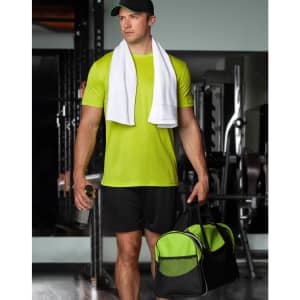 A sports travel bag in black and green, held by a person in a bright green athletic outfit with a towel draped around their neck.