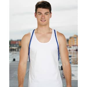 A model wearing a plain white tank top with blue straps, standing by a waterfront. The background features a dock and buildings.