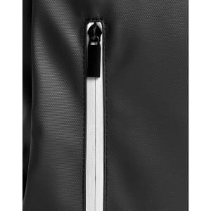 A close-up of a black backpack featuring a zippered compartment with a contrasting white zipper.