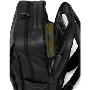 A black PU backpack with multiple compartments and zippers, showcasing interior storage options.