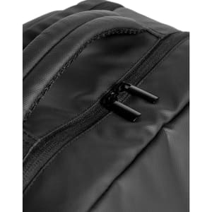 A close-up view of a black PU backpack featuring a zippered pocket and a sleek design. The backpack has a logo.