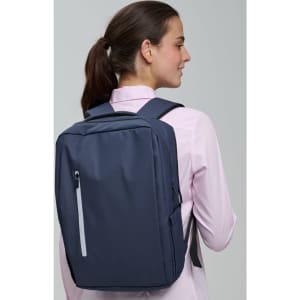 A navy blue backpack with multiple compartments and a logo, worn on the back of a person.
