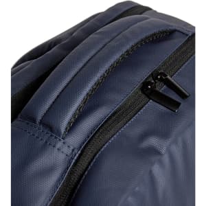 A dark navy backpack featuring a smooth texture and zippered compartments. The product has a logo.