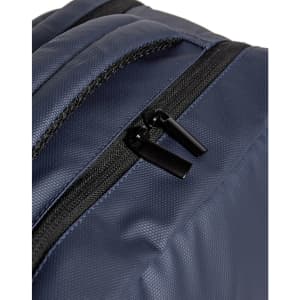A navy blue backpack features black zippers and a textured fabric. It has a simple design with no visible logos.