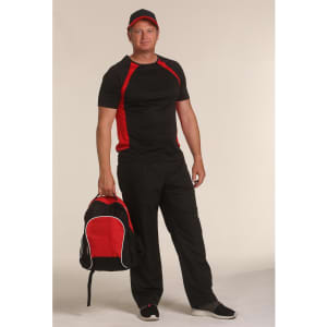 A man in a black and red athletic outfit holds a black and red backpack, wearing a matching cap.