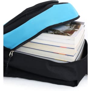 A black backpack with a blue zipper, partially open to reveal several neatly stacked books inside.