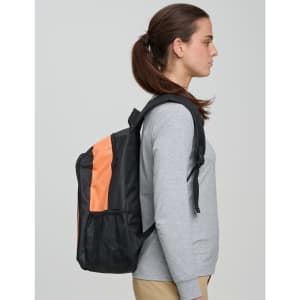 A black backpack with an orange stripe worn by a woman, featuring a logo on the front.