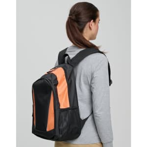 A black and orange backpack is worn on the back of a person, showcasing its stylish design and spacious compartments.