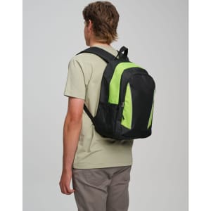 A black and lime green backpack is worn by a person from behind, showcasing its design and colour contrast.